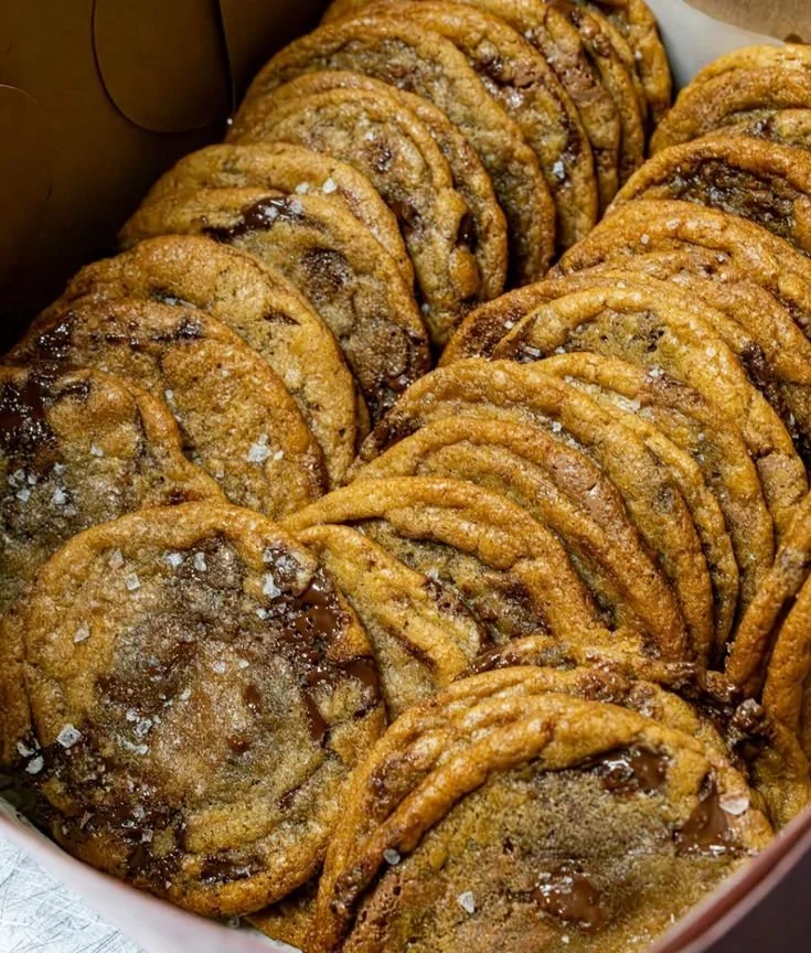 Freshly baked chocolate chip cookies on a cooling rack